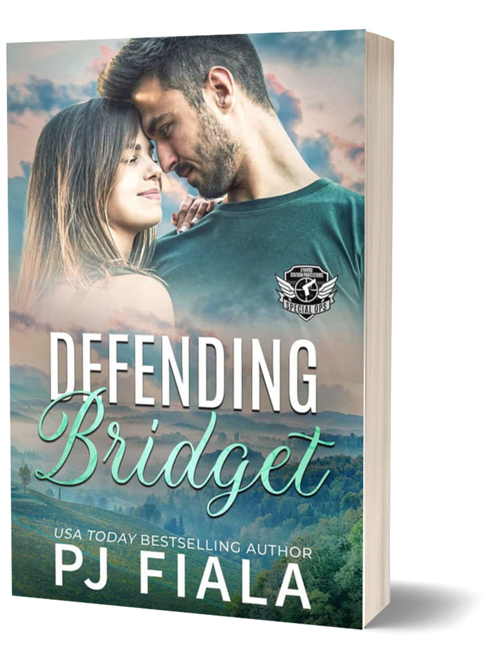 3D paperback of Defending Bridget by USA Today bestselling author PJ Fiala. A dark-haired couple leans forehead to forehead, gazing into each other's eyes against a peaceful blue-green mountain landscape with misty hills and pastel clouds. Part of the Lynyrd Station Protectors: Special Ops series.