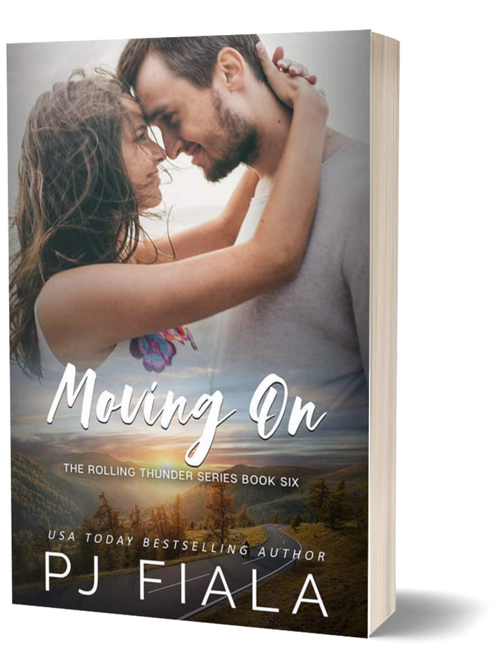 3D paperback edition of Moving On by USA Today bestselling author PJ Fiala. The cover features a couple holding each other with their foreheads touching, set against a scenic mountain landscape and winding country road.