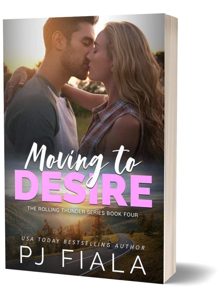3D paperback edition of Moving to Desire by USA Today bestselling author PJ Fiala. The cover features a passionate couple kissing at sunset with a peaceful mountain landscape in the background.