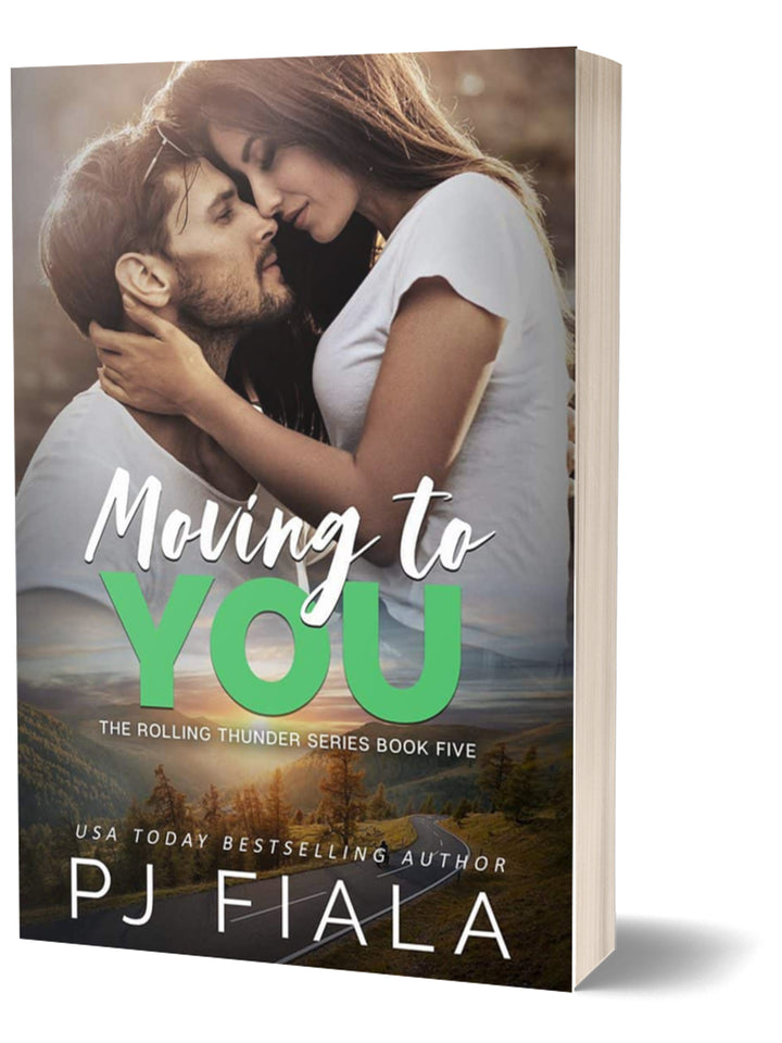  3D paperback edition of Moving to You by USA Today bestselling author PJ Fiala. A bearded hero and brunette heroine share an intimate embrace with a mountain landscape stretching beneath them.