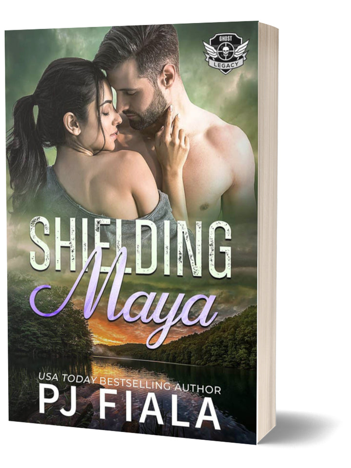 Paperback cover for Shielding Maya by USA Today bestselling author PJ Fiala. A dark-haired woman with a ponytail and a shirtless bearded man share a close embrace above a peaceful lake at sunset, part of the Ghost Legacy romantic suspense series.